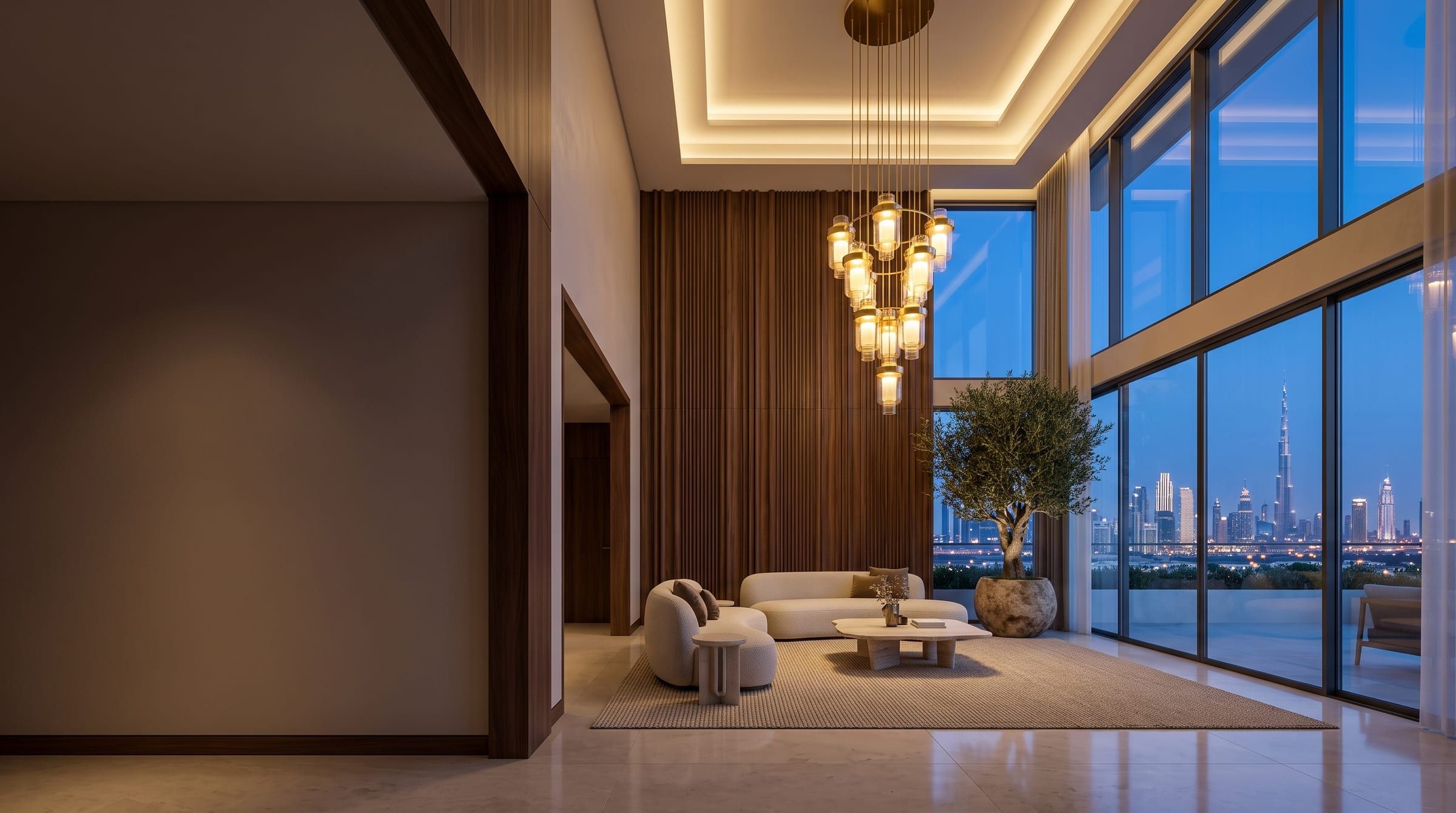 Double-height living room at dusk, with a tiered glass chandelier, fluted walnut wall and full-height glazing onto the Dubai skyline