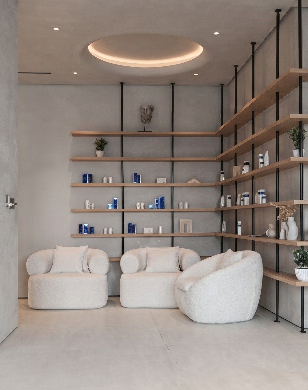 Slim oak shelves on blackened steel uprights, with bouclé armchairs under a lit circular cove.